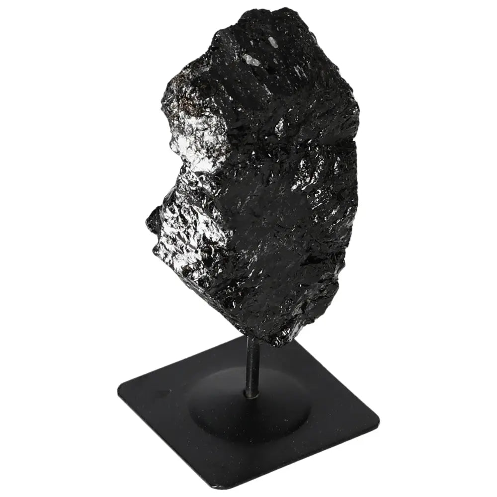 Rough black tourmaline crystal on a metal stand by Sylvia Crystals, showcasing natural elegance and diverse colors in home decor.