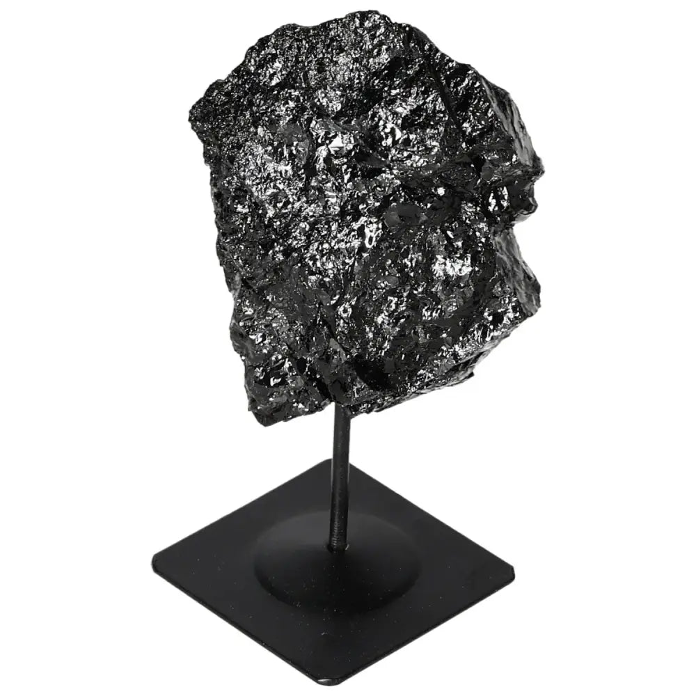 Black rough tourmaline crystal on a metal stand from Sylvia Crystals, showcasing natural beauty and diverse color palette.