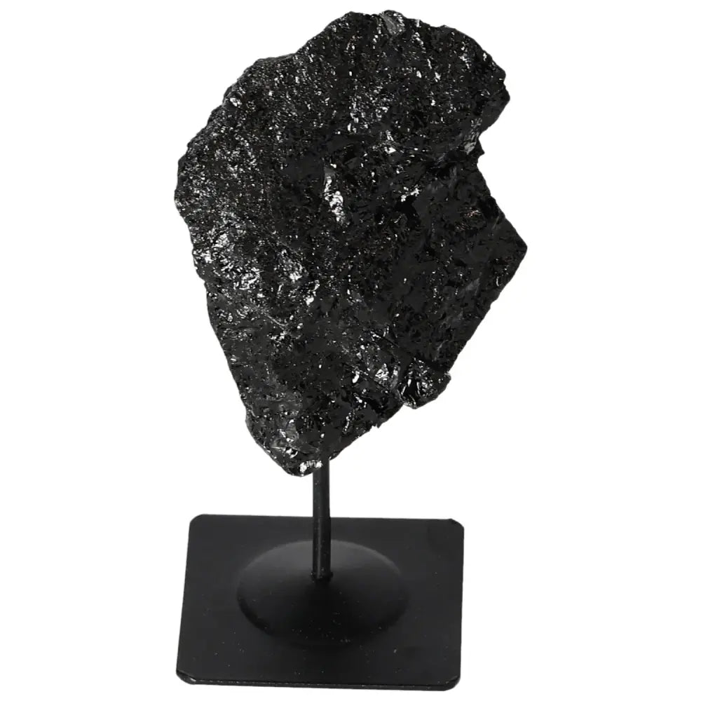 Rough black tourmaline crystal showcased on a metal stand from Sylvia Crystals.