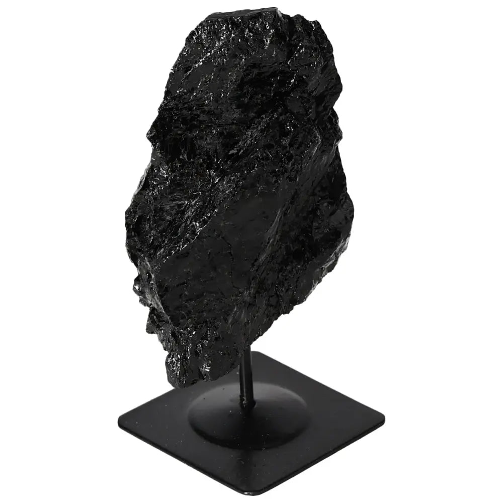 Rough black tourmaline on metal stand, premium decor piece by Sylvia Crystals, showcasing natural energy-balancing qualities.