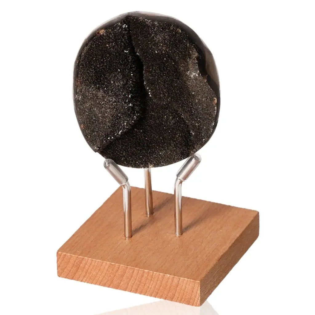 Septarian "Dragon Stone" mineral on wooden base, symbolizing power and endurance, with multidimensional physical and spiritual properties.