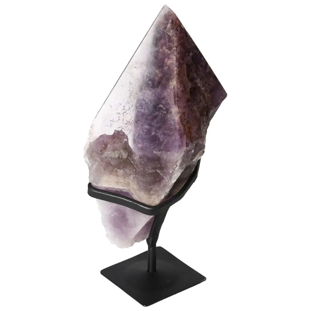 Seven Point Polished Amethyst from Sylvia Crystals displayed on a stand, showcasing its premium quality and tranquil beauty.