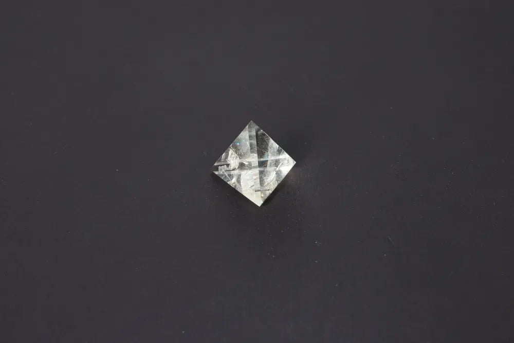 Smoky Quartz Pyramid 4 cm on a dark background showcasing its translucent tones for grounding energy and protection.