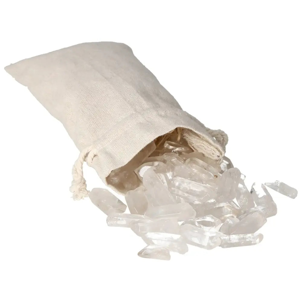 Tumbled Clear Quartz Points spilling from a beige pouch, exemplifying energy harmony and purity from Sylvia Crystals.