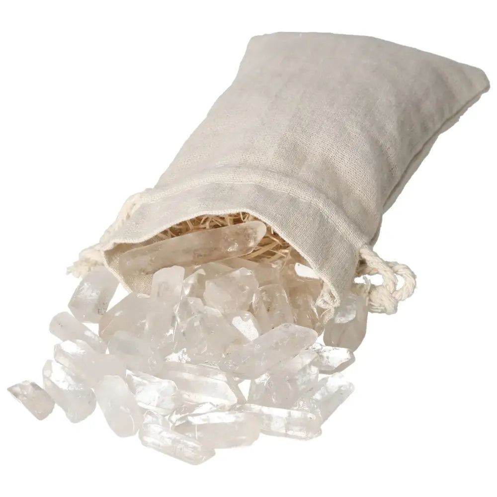 Tumbled Clear Quartz Points spilling from a linen bag, showcasing their clarity and spiritual properties from Sylvia Crystals.
