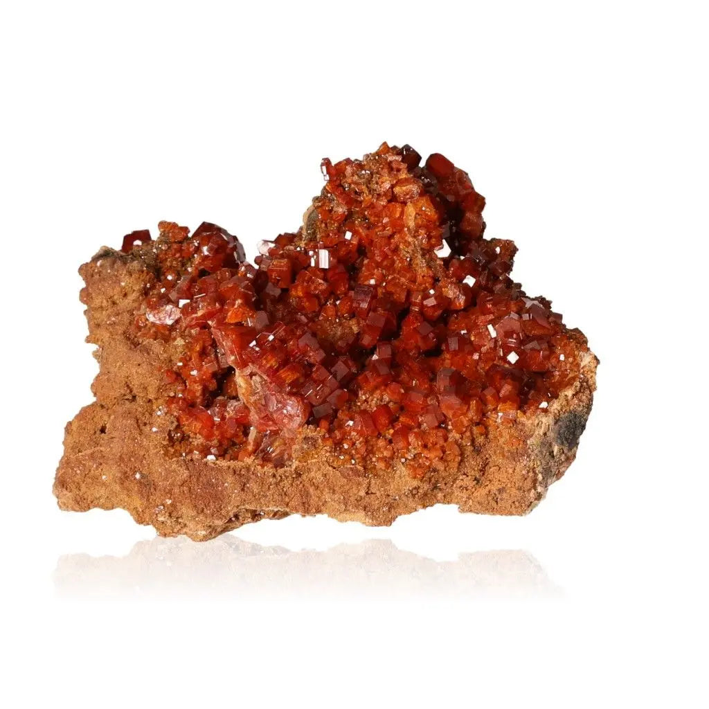 Vibrant red-orange Vanadinite Druze crystal on a brown rock base, known for enhancing focus and creativity, perfect for collectors.