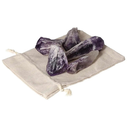 Amethyst Point L crystals on a beige pouch, highlighting their deep purple hues and natural beauty from Sylvia Crystals.