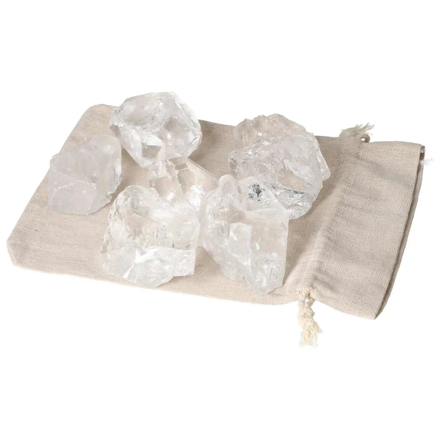 Quartz Clear crystals on a beige cloth, showcasing their clarity and elegance; perfect for enhancing spiritual harmony and balance.