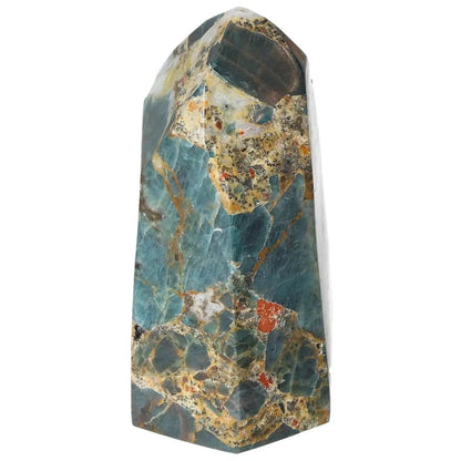Apatite Obelisk by Sylvia Crystals, showcasing exquisite blue-green hues, symbolizing harmony and spiritual energy, isolated on white.