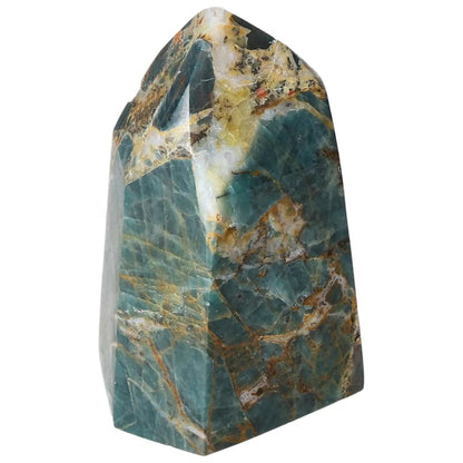 Apatite Obelisk by Sylvia Crystals showcasing its vibrant green hues and intricate patterns, symbolizing spiritual energy and elegance.