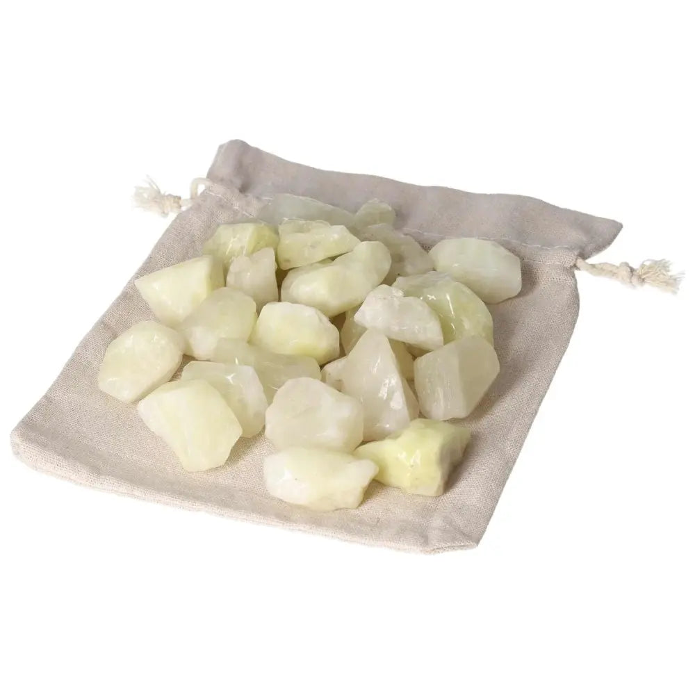 Pile of premium Tumbled Sulphur crystals on a drawstring pouch, showcasing their vibrant yellow hue for purity and cleansing.