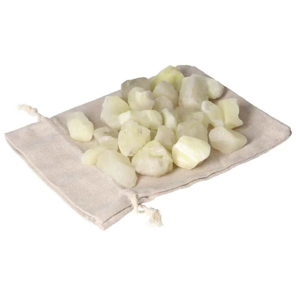 Tumbled Sulphur crystals from Sylvia Crystals, showcasing vibrant yellow stones on a natural fabric pouch for purity and cleansing.