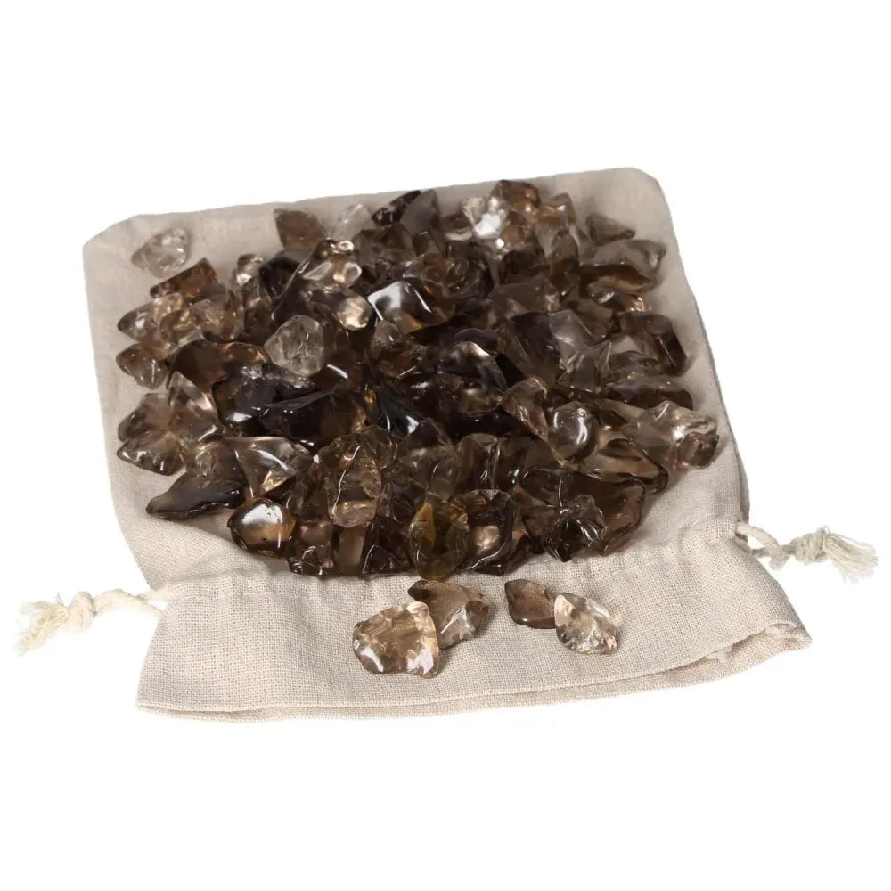 Tumbled Smoky Quartz stones displayed in a beige pouch, promoting grounding energy and practical thinking.