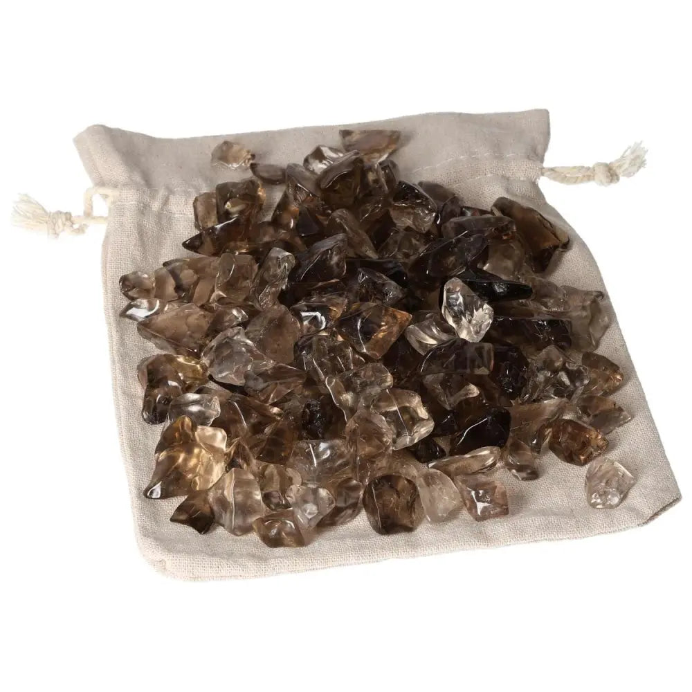 Tumbled Smoky Quartz crystals from Sylvia Crystals on a cloth bag, known for grounding and decision-making support for professionals.