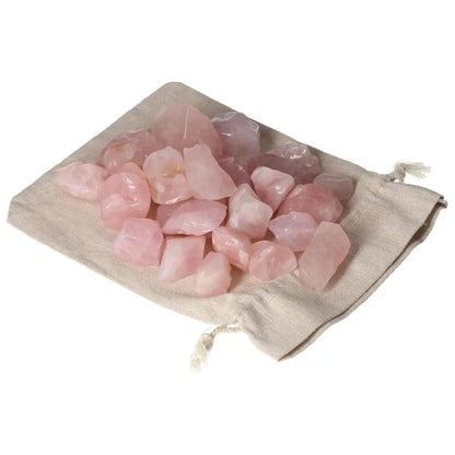 Tumbled Rose Quartz stones on a linen pouch, promoting emotional healing and love, from Sylvia Crystals collection.