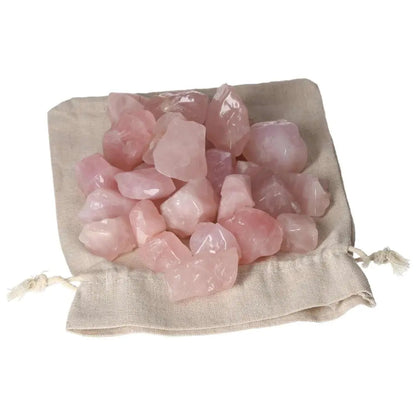 Luxurious tumbled Rose Quartz stones in a linen pouch, symbolizing love and emotional healing, by Sylvia Crystals.