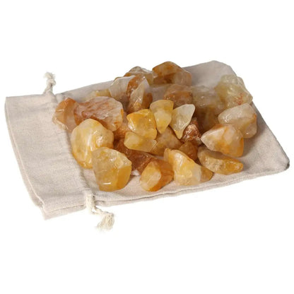 Tumbled Yellow Hematoide crystals on cloth, showcasing vibrant golden hues, symbolizing luxury and spiritual harmony.