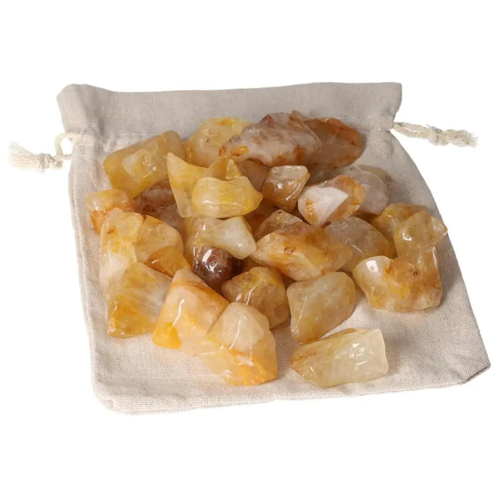 Tumbled Yellow Hematoide crystals in a drawstring bag, premium gemstone by Sylvia Crystals, golden hues, elegance and luxury.