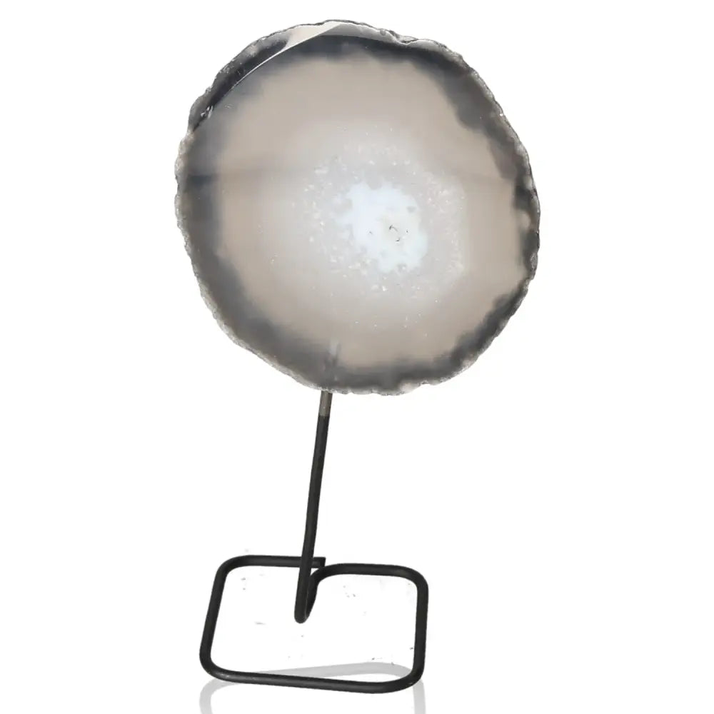 Elegant agate slice on a metal stand, promoting balance and tranquility in home decor, with a sleek and modern design.