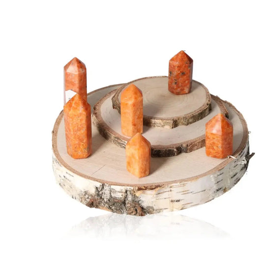 Orchid calcite obelisk stones on a wooden stand, symbolizing willpower, vitality, and creativity, ideal for boosting energy and motivation.
