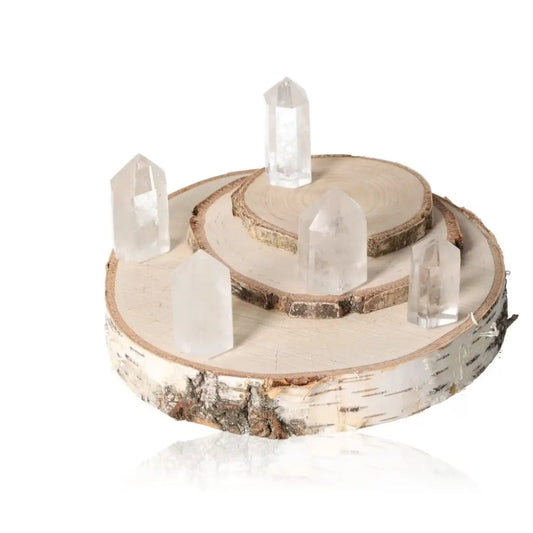 Crystal Quartz Obelisk Tower Points displayed on wooden platforms for energy purification and harmonizing negative vibrations.