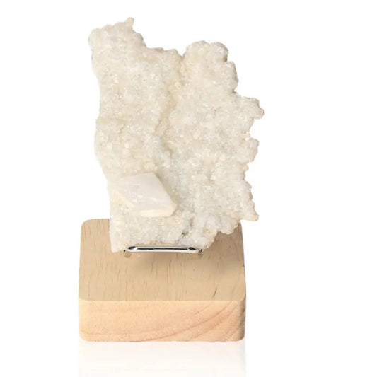 Quartz with Calcite crystal displayed on a wooden stand, showcasing its dual-energy synergy and unique combination for enhancing spaces.