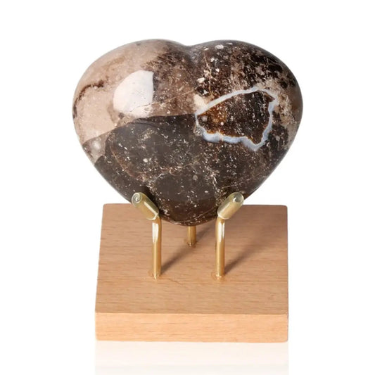 Sardonyx Heart gemstone on stand, promoting strength and resilience, enhancing Root and Sacral Chakras, mystical allure.