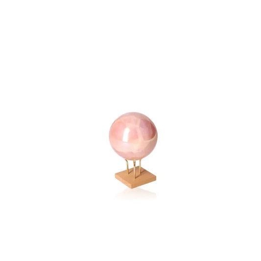Rose Quartz Sphere on stand, showcasing natural pink hues and polished finish, from Sylvia Crystals. Ethically sourced for emotional healing.