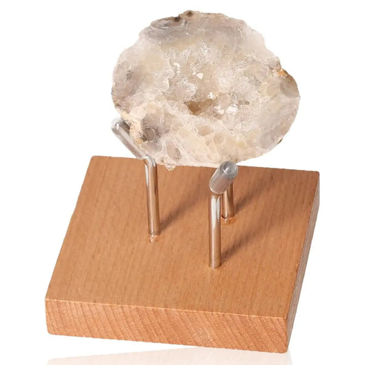 Mini Agate Geode on wooden stand, symbolizing balance and tranquility, known for harmonizing body, mind, and emotions.
