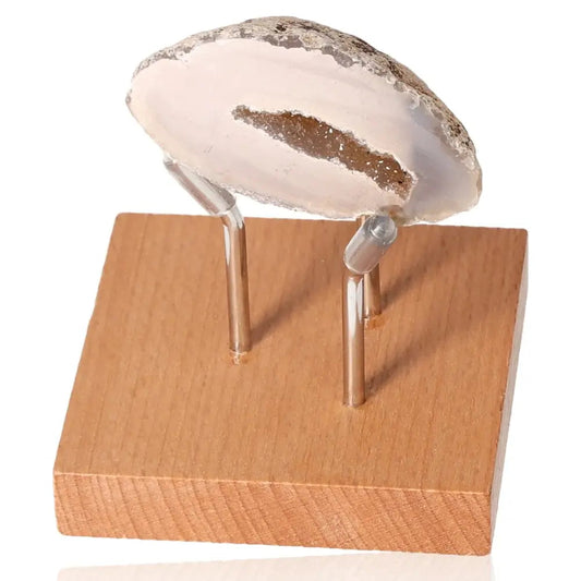 Mini Agate Geode on wooden stand showcasing natural beauty and vivid hues, offering balance and serenity.