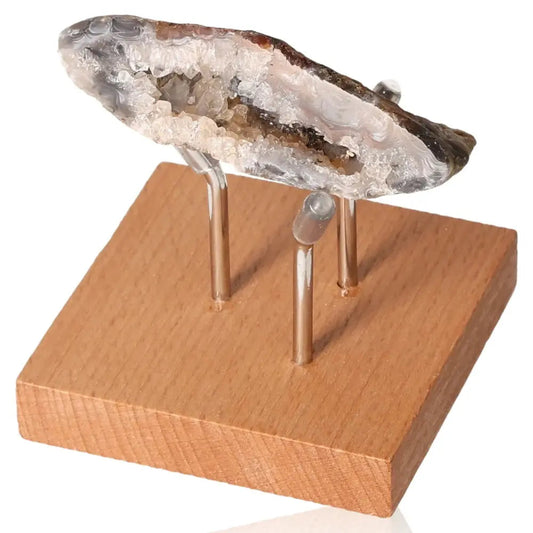 Elegant Mini Agate Geode on Wooden Stand, showcasing natural patterns and vibrant hues, a symbol of tranquility and elegance.