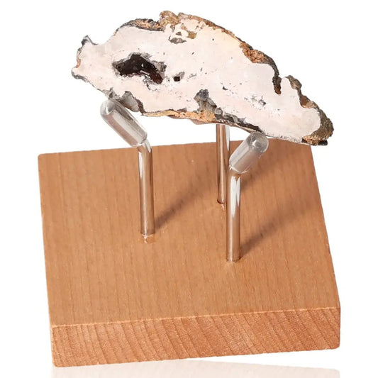 Mini Agate Geode on wooden stand, showcasing unique natural patterns and colors, promoting tranquility and aesthetic appeal at home.