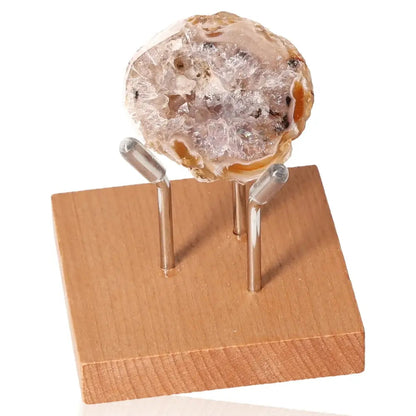 Mini Agate Geode on a wooden stand showcasing natural patterns and layers of crystal, perfect for home decor and tranquility.