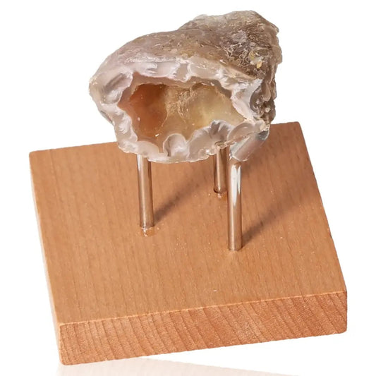 Mini Agate Geode on wooden stand showcasing natural beauty and energy balance qualities.