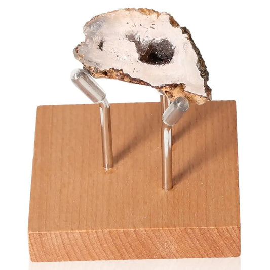 Mini Agate Geode on a wooden stand showcasing its natural beauty and energy-balancing properties.