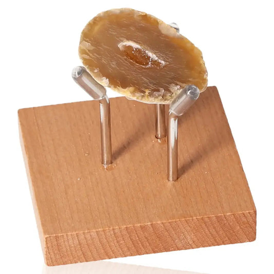 Mini Agate Geode on wooden stand, showcasing its natural beauty and tranquil properties for home decor and spiritual harmony.