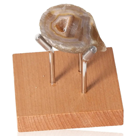 Mini Agate Geode on wooden stand, showcasing natural patterns and mystical beauty