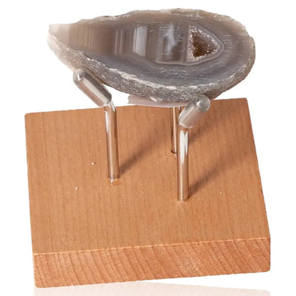Mini Agate Geode on wooden stand, showcasing its natural beauty and calming energy.
