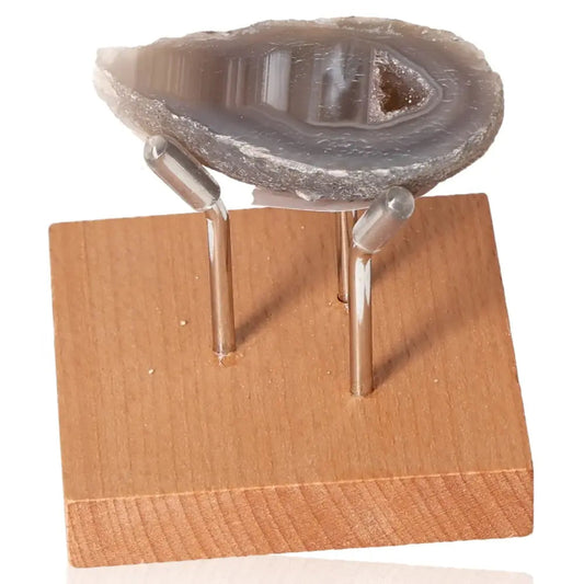 Mini Agate Geode on wooden stand, showcasing its natural beauty and calming energy.