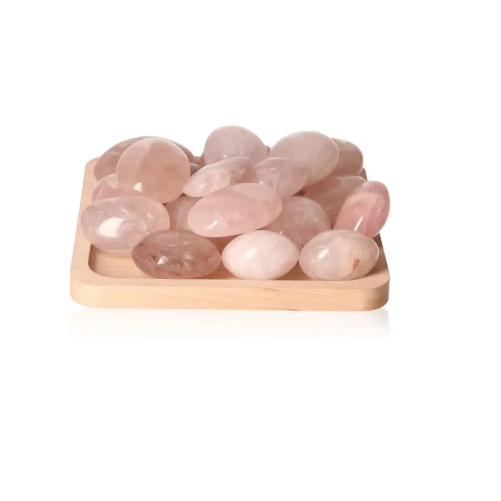 Rose Quartz Palm Stones from Sylvia Crystals, known for emotional healing and self-love, displayed on a wooden tray