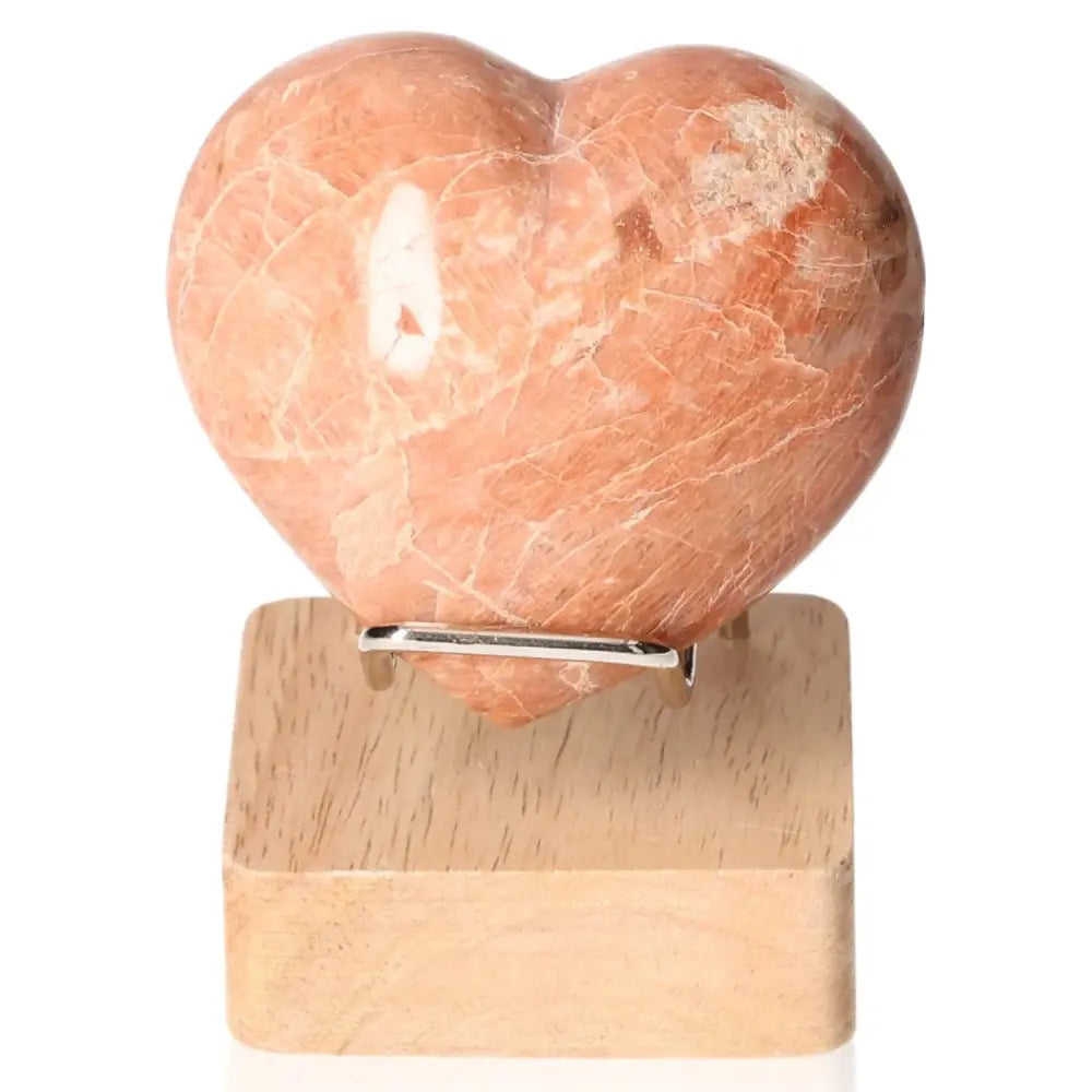 Peach Moonstone Heart for emotional balance and intuition, ideal for restful sleep and enhancing attractiveness. Stand not included.