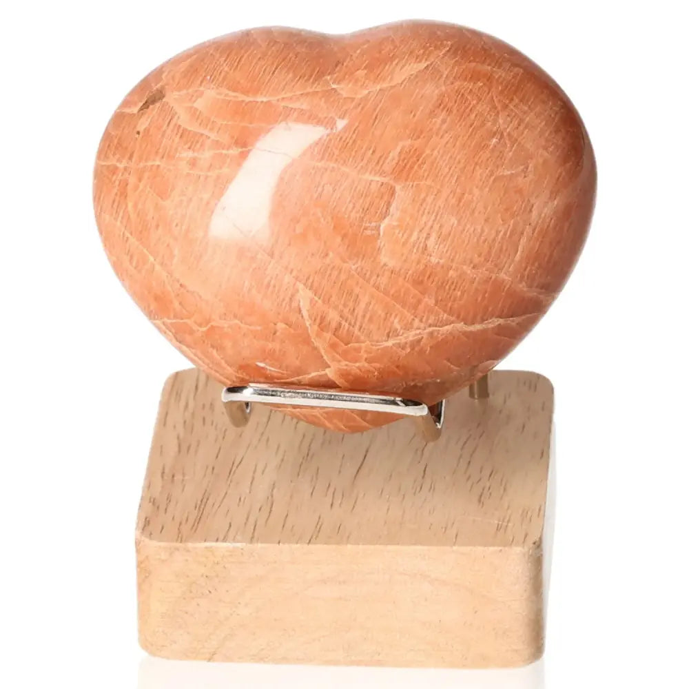 Peach Moonstone Heart for emotional balance and intuition, enhances attractiveness, protects against nightmares; stand not included.