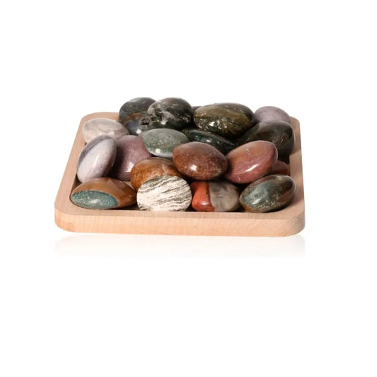 Assorted Ocean Jasper Palm Stones in a wooden tray, showcasing natural patterns and colors for emotional stability and positivity.