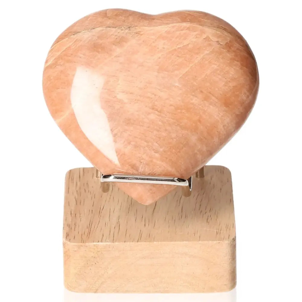 Peach Moonstone Heart enhances emotional balance and intuition, protects against nightmares; perfect for restful sleep. Stand not included.