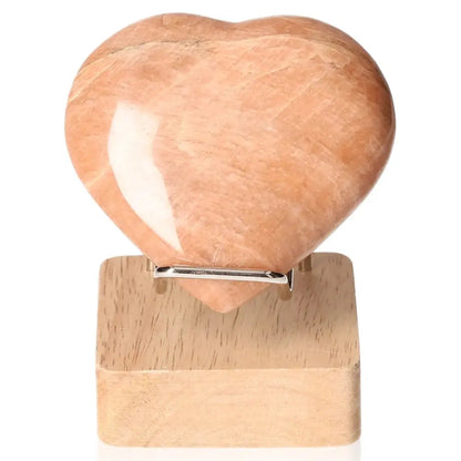 Peach Moonstone Heart enhances emotional balance and intuition, protects against nightmares; perfect for restful sleep. Stand not included.
