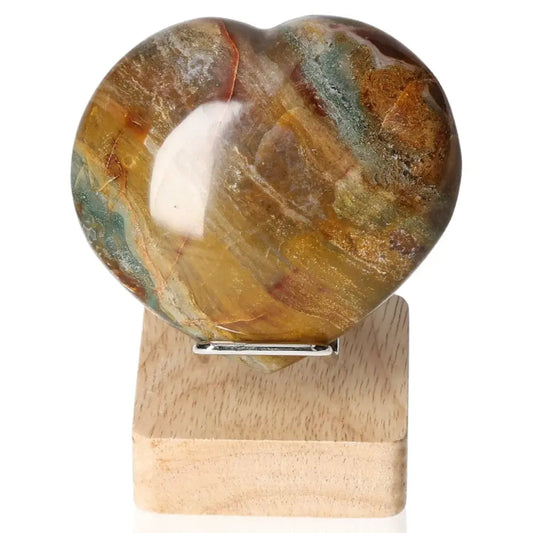 Jasper Heart gemstone on a wooden stand, showcasing its unique swirling patterns and natural beauty by Sylvia Crystals.