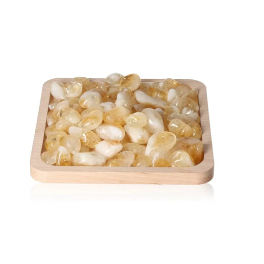 Tumbled Citrine M gemstones in a wooden tray from Sylvia Crystals, symbolizing abundance, positivity, and transformation.