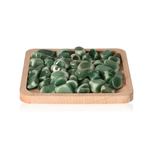 Wooden tray filled with smooth tumbled aventurine stones, showcasing their glossy green hues and polished finish.