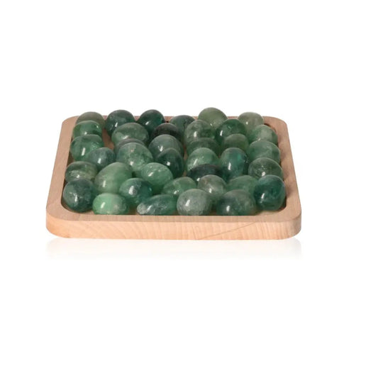 Tray of tumbled transparent fluorite stones enhancing creativity and clarity, perfect for intellectual growth and personal development.