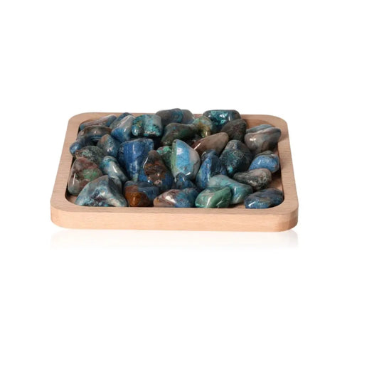 Shattuckite gemstones on wooden tray, known for heart chakra activation and spiritual transformation, promoting healing and wisdom.